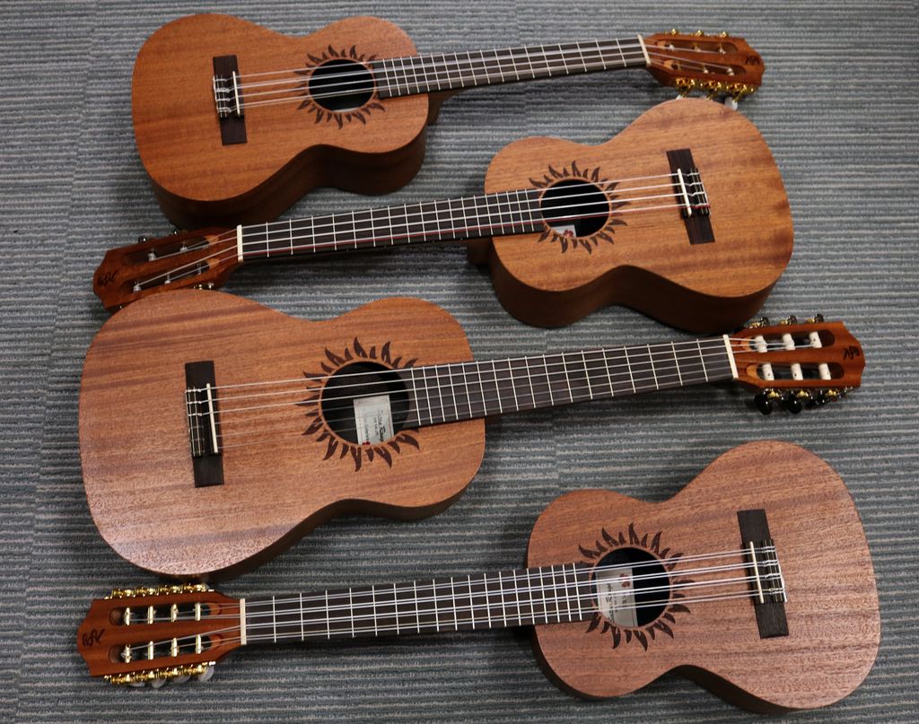 Top to bottom: six string tenor, five string tenor, guitarlele, eight string tenor, all made by Baton Rouge
