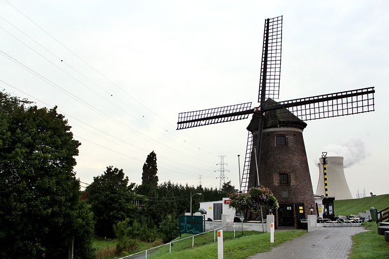 Windmill in Doel with a nuclear plant in the background
