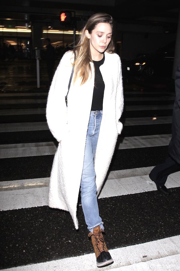 Olsens Anonymous Blog Elizabeth Olsen Style Airport Look Long White Textured Coat Tucked Black Shirt Light Denim Boyfriend Jeans Sorel Winter Rain Boots