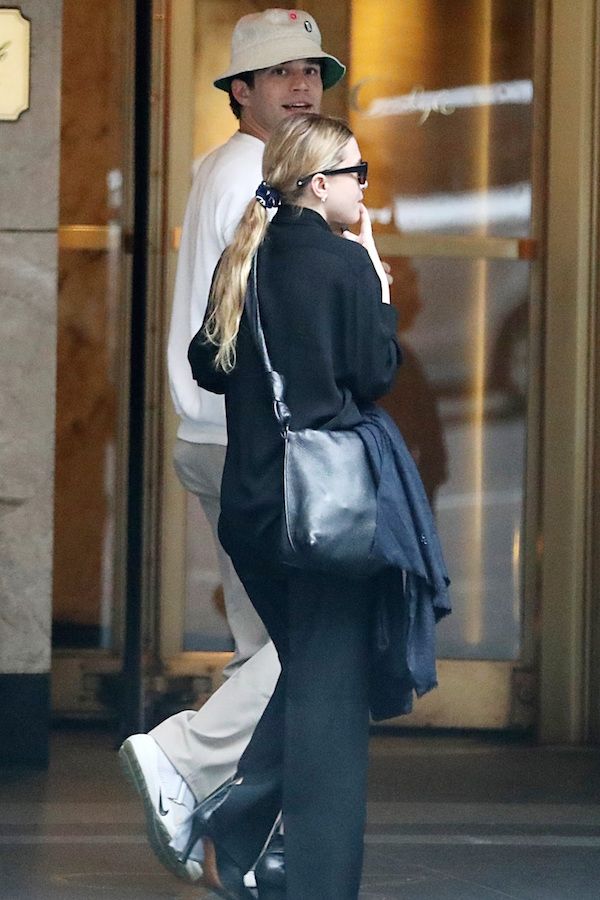 Olsens Anonymous Blog Ashley Olsen Twins Style Louis Eisner New York City NYC Low Ponytail Scrunchy Trend Printed Hair Tie Elastic Silky Blouse Top Black Slit Split Pants Heeled Leather Ankle Boots Booties
