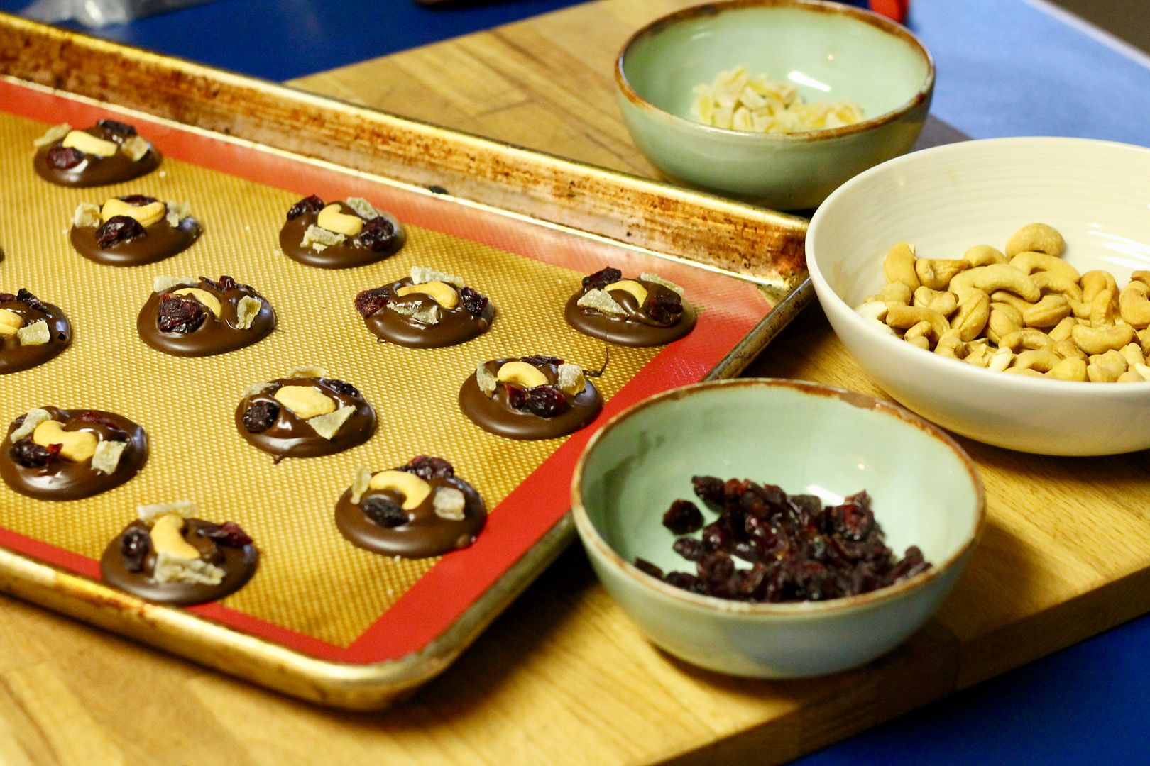 topping mendiants with dried fruit and nuts
